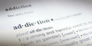 a view of a dictionary excerpt defining addiction